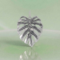 Luxe Silver Plate Dimensional Monstera Leaf Charm on green background