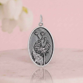 Luxe Silver Plate Oval Dandelion Charm on pink background