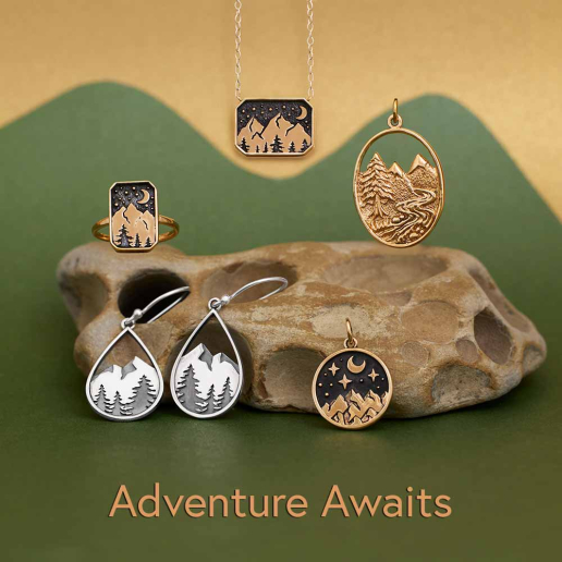Bronze Mountain Jewelry and charms on green background