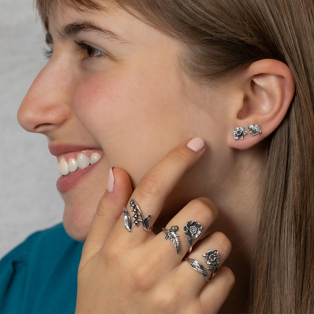 Women wearing silver flower rings