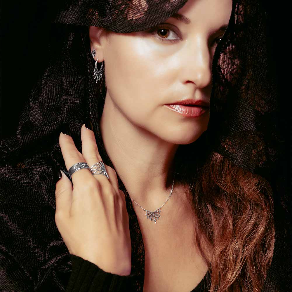 Woman wearing black clothing with silver jewelry