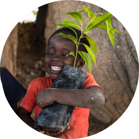 Boy Hugging potted baby tree