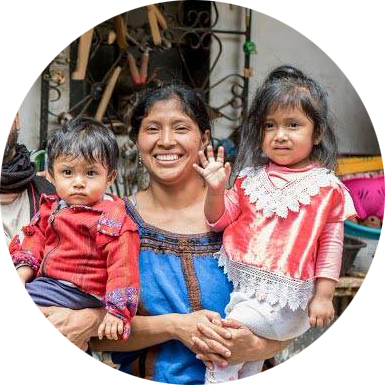 Woman holding two young children
