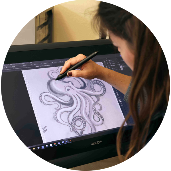 Woman drawing octopus charm on computer