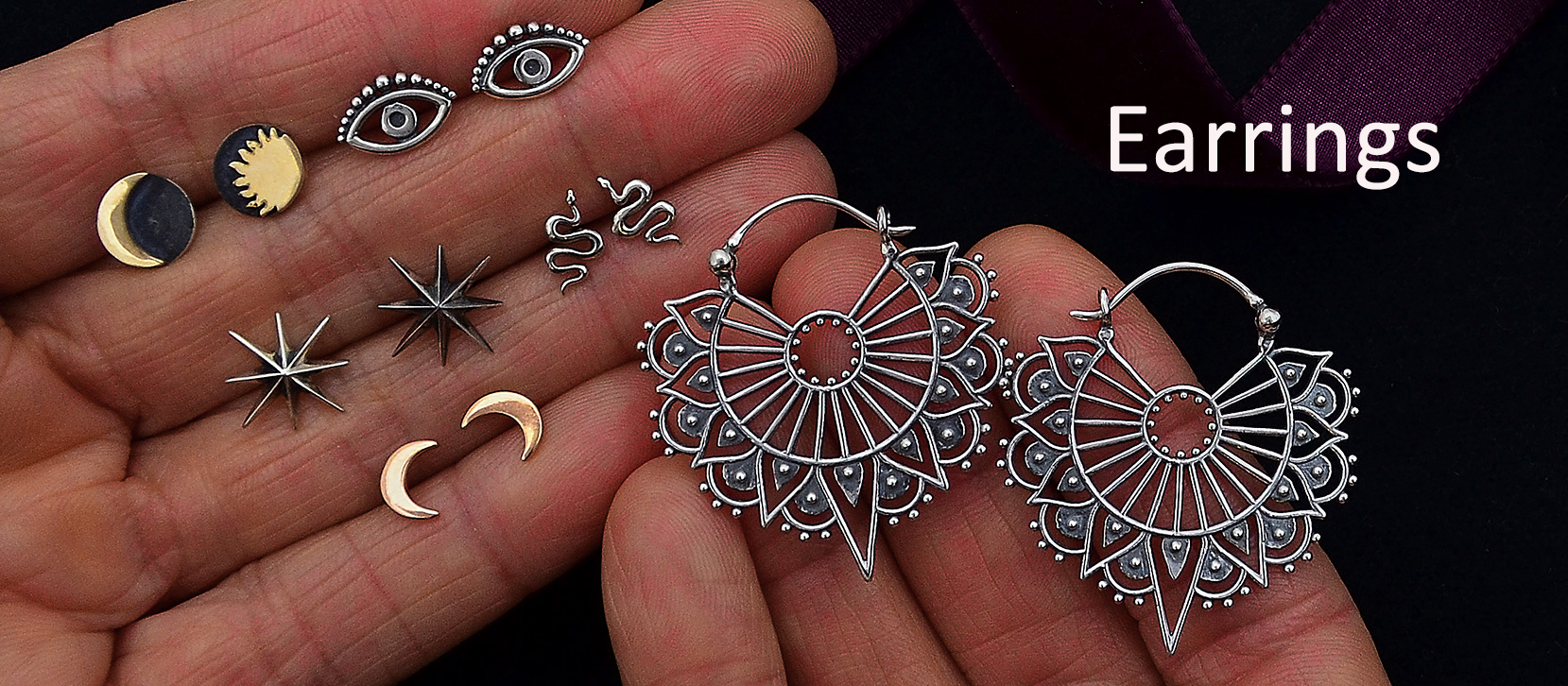 Hand holding earrings - shop earrings