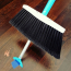 Close-up of the SweepEasy&reg; Broom&rsquo;s built-in retractable scraper, ideal for removing tough debris like gum and stickers.