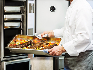 Food in a stainless steel tray being put inside of the heated ScanBox