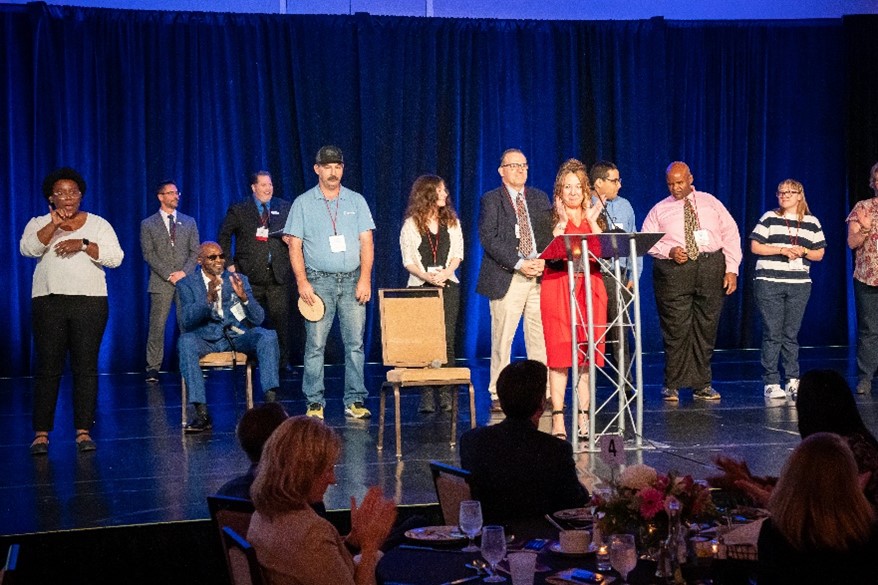 A group of 2024 Achievement Award winners receive their award during the 2024 ceremony.